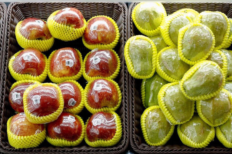 Fruit packaged in plastic are on display at a supermarket in Beijing, China. Photo: Reuters